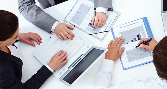 Business meeting between consultants and clients discussing technical solutions, modern office setting with presentation materials, showing professional consulting services